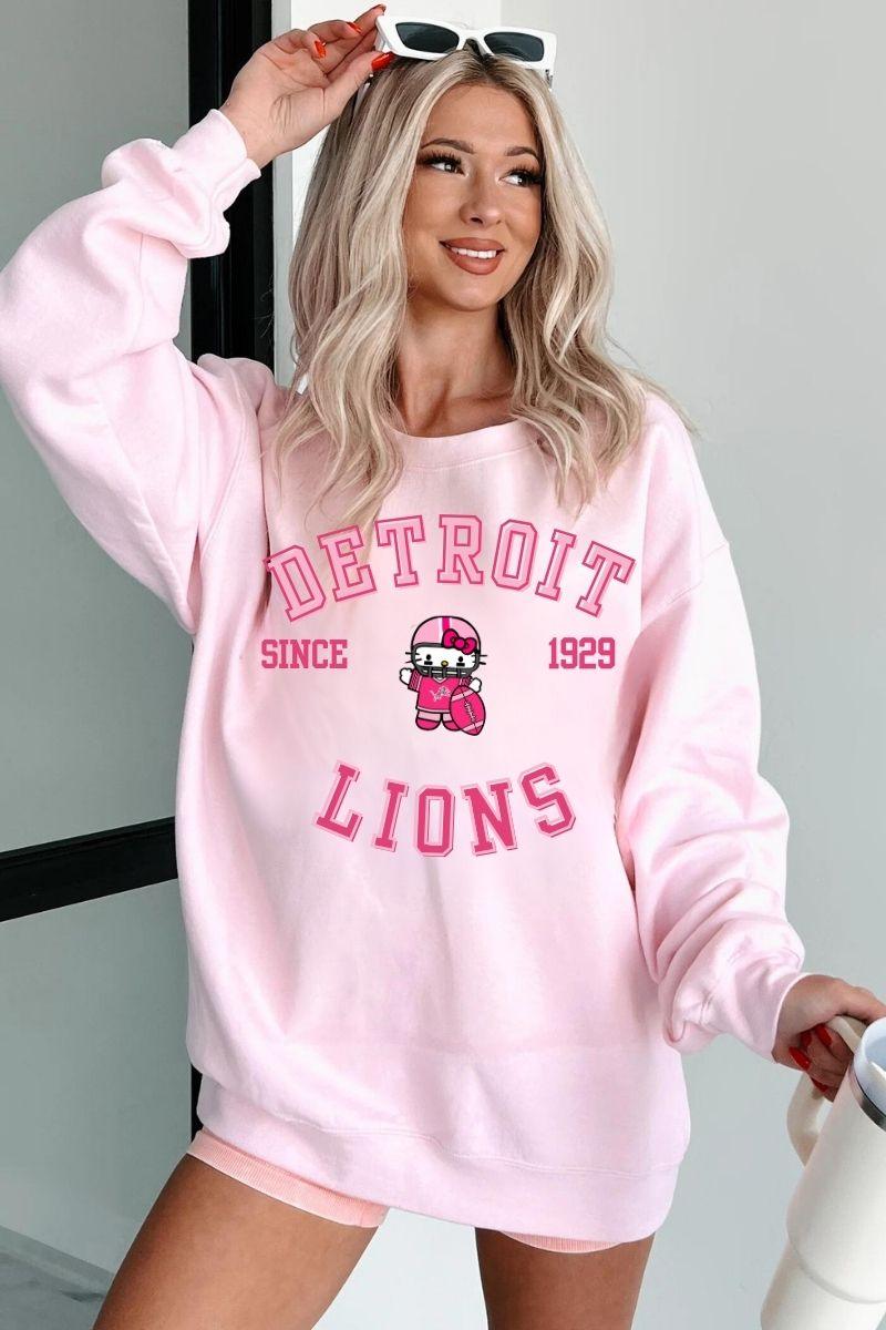 The Detroit Lions x Hello Kitty 2024 Sweatshirt&nbsp;is a vibrant and playful collaboration that merges NFL sports culture with the iconic charm of Hello Kitty. The standout feature of this Sweatshirt is the pink base , which offers a fun and fresh take on traditional football apparel, making it perfect for fans who want to express both their love for the Lions and their appreciation for Hello Kitty’s timeless appeal. The front of the hoodie features the Detroit Lions logo in bold Pink, paired with the team